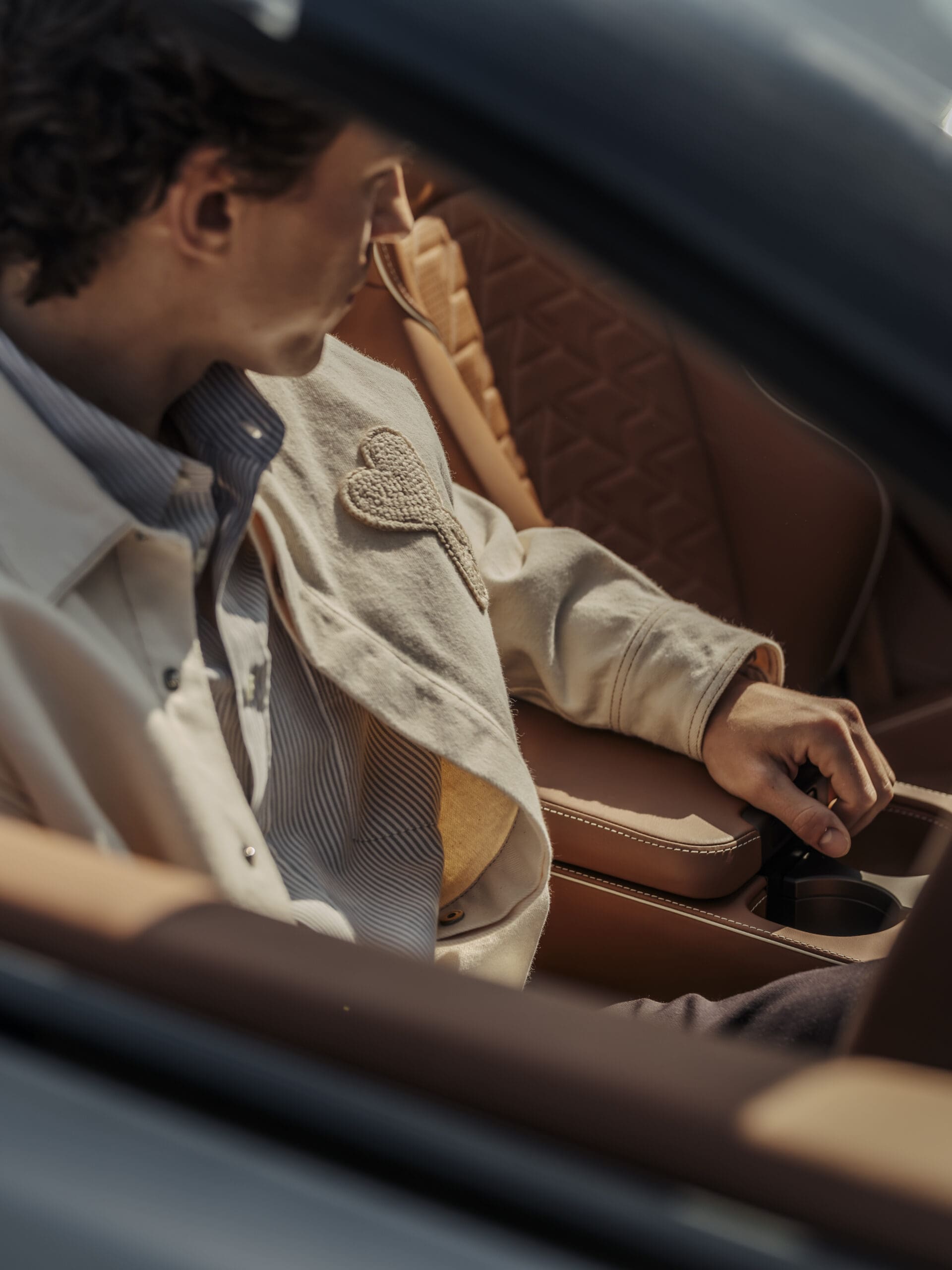 Tom Holland, founder of Bero, inside an Aston Martin